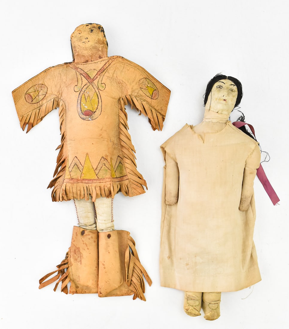 INDIGENOUS SOUTHERN PLAINS BUCKSKIN AND CLOTH DOLLS; 19TH CENTURY: This lot includes an Indigenous Southern Plains buckskin doll and a cloth doll of a woman, circa 19th century. The lot measures 1" high, 11" wide, and 15.5" deep.
