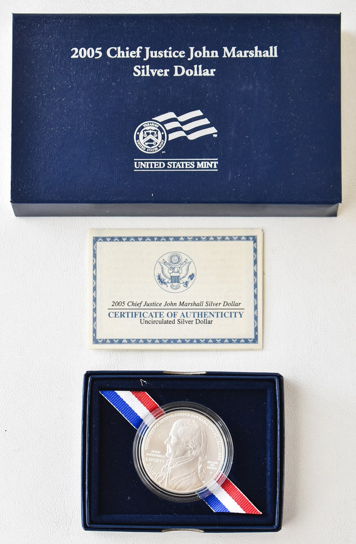 2005 UNITED STATES MINT CHIEF JUSTICE JOHN MARSHALL UNCIRCULATED SILVER DOLLAR: A 2005 United States mint Chief Justice John Marshall uncirculated silver dollar. The lot measures 1" high, 6" wide, and 3.5" deep.