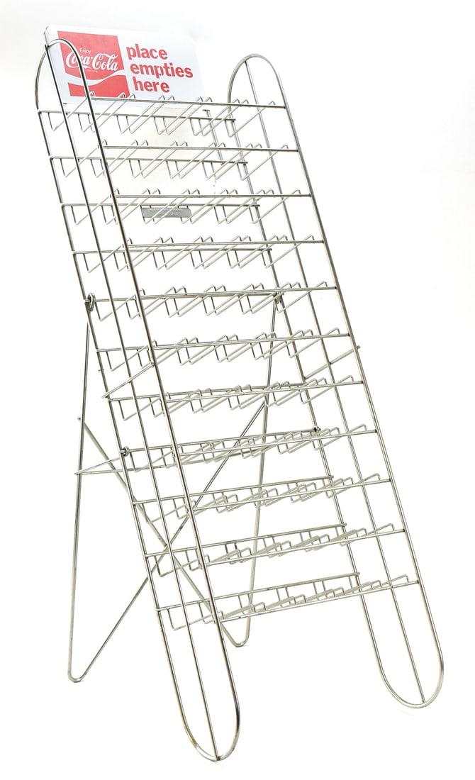 KASPER WIRE WORKS COCA-COLA EMPTY BOTTLE RETURN RACK: A Kasper Wire Works Enjoy Coca-Cola empty bottle return rack with eleven shelves, circa 1960-1970s. The rack measures 38.5" height, 14" wide, and 18" deep.