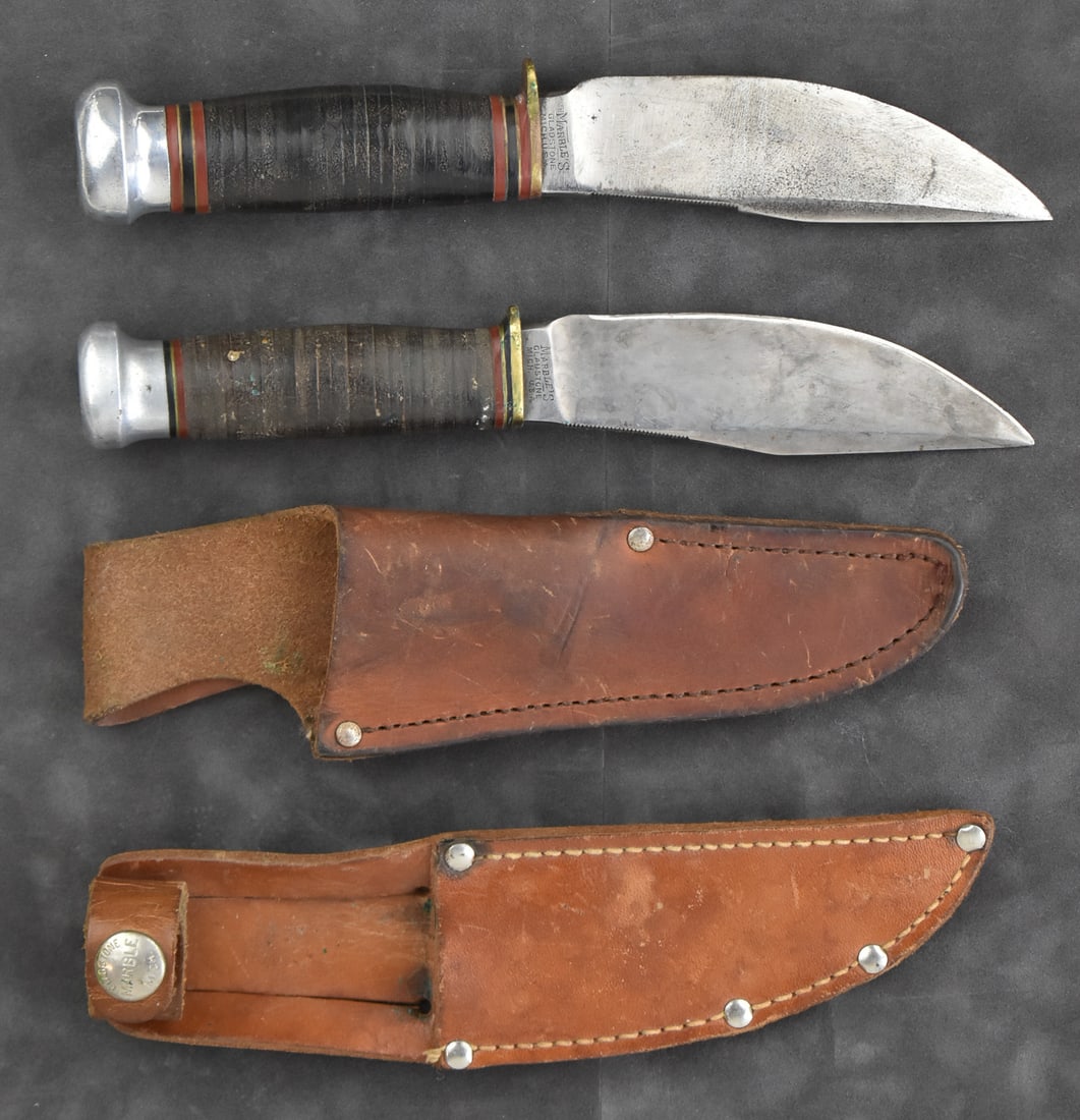 PAIR OF ANTIQUE MARBLE'S WOODCRAFT KNIVES: A pair of antique Marble's Woodcraft fixed blade knives made in Gladstone, Michigan. One knife is marked with a 1918 patent. Both knives include leather sheaths and stacked leather handles. Each knife