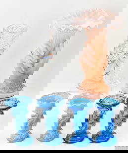 COLLECTION OF BOUQUET-THEMED BUD VASES: A collection of six bud vases with hands holding a bouquet include a pink opaline glass vase measuring 8" H x 5" W x 3" D, two blue opaline glass vases, two blue glass vases, and a clear pressed glass