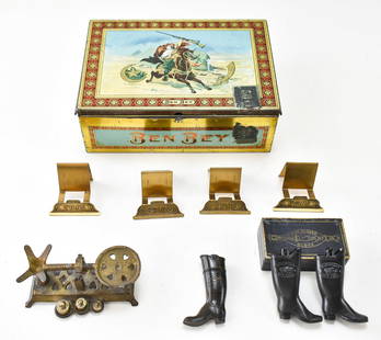 COLLECTION OF ANTIQUE TOBACCO & HOUSEHOLD ITEMS: Includes an antique Ben Bey cigar tin measuring 3" H x 9" W x 6.5" D, four small Evans brass stands, a brass scale, a Hood Rubber Company boot match safe, and Goodyear Mfg. miniature rubber boots in o