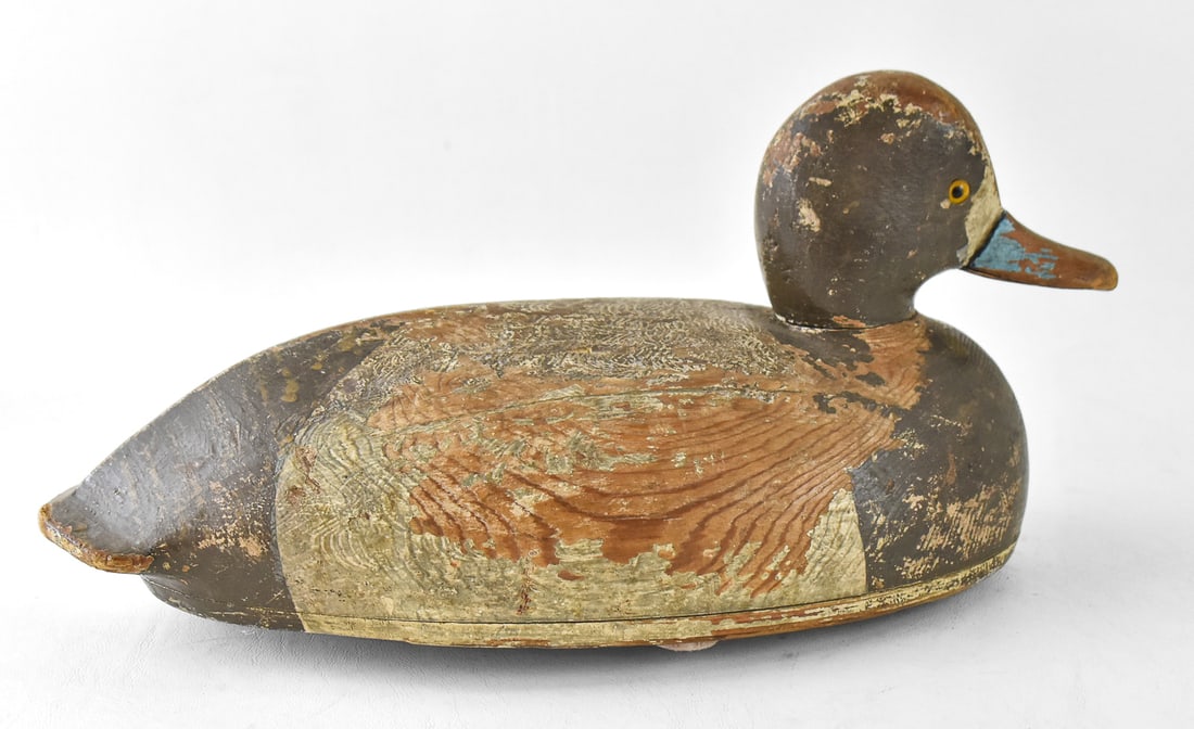 VINTAGE RUDDY DUCK OR LESSER SCAUP DECOY: A wooden painted waterfowl decoy of either a ruddy duck or a lesser scaup, circa early-mid 20th century. The item measures 7" H x 5.5" W x 16" D.
