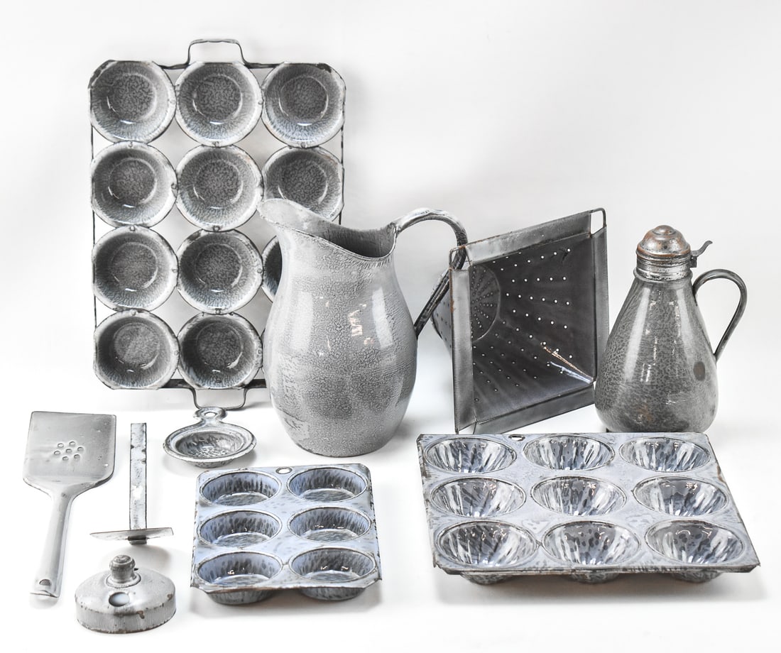 ASSORTED GRANITEWARE KITCHENWARE: An assortment of graniteware kitchen implements including spatulas, strainers, banking pans, pitchers, etc. The overall dimensions of this lot for shipping purposes are about 12" H x 24" W x 13" D.