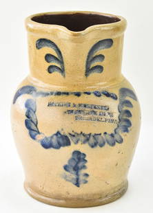 REMMEY POTTERY PHILADELPHIA ADVERTISING STONEWARE PITCHER: A Richard C. Remmey stoneware pitcher advertising for Hopkins and M' Elveney - Philadelphia, Pennsylvania; with cobalt leaves, circa 1870s. Measures 10" H x 7" W x 8.5" D.
