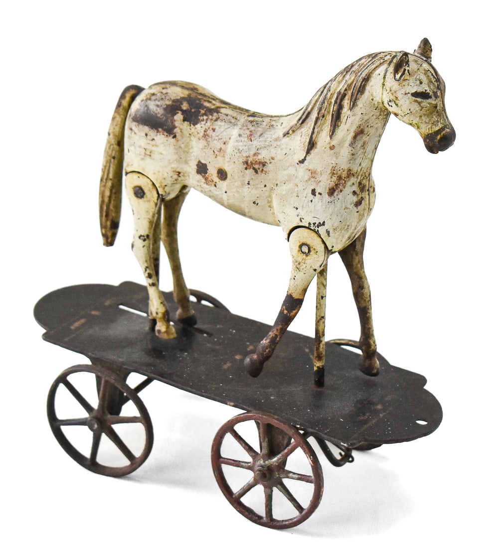 IVES WALKING HORSE PULL TOY: An Ives cast iron walking horse pull toy with jointed legs, circa 1893. The item measures 9.5" H x 9" W x 4" D.