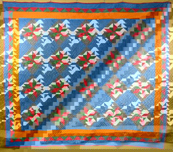 HANDMADE STAR QUILT, C. 1833: A handmade star quilt with green and red stars and a light blue field, with a blue, red, and orange border. Made in 1833 by Catherine Krauss of Ohio. The quilt has a tag with the maker's information a