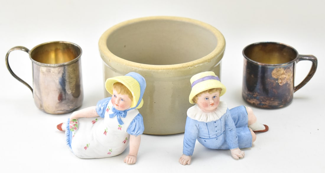 ASSORTED SILVER, STONEWARE, & MORE: This lot includes two bisque porcelain figurines which may be German, one stoneware cylindrical jar, one silverplate cup, an one sterling silver cup weighing 78.6 grams. The bisque porcelain figurines