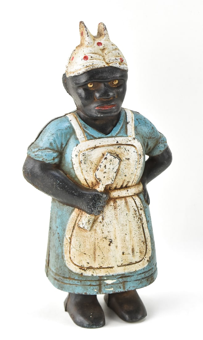 BLACK AMERICANA CAST IRON AUNT JEMIMA COIN BANK: A circa 1920s "Aunt Jemima" cast iron coin bank measuring 12" H x 7" W x 4" D.