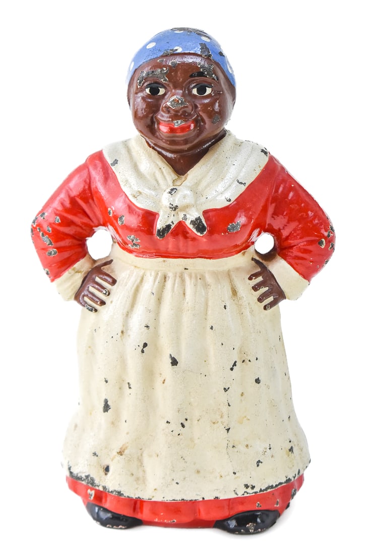BLACK AMERICANA CAST IRON AUNT JEMIMA DOOR STOP: A circa 1920s painted cast iron "Aunt Jemima" door stop, measuring 8.5" H x 5.5" W x 4" D.
