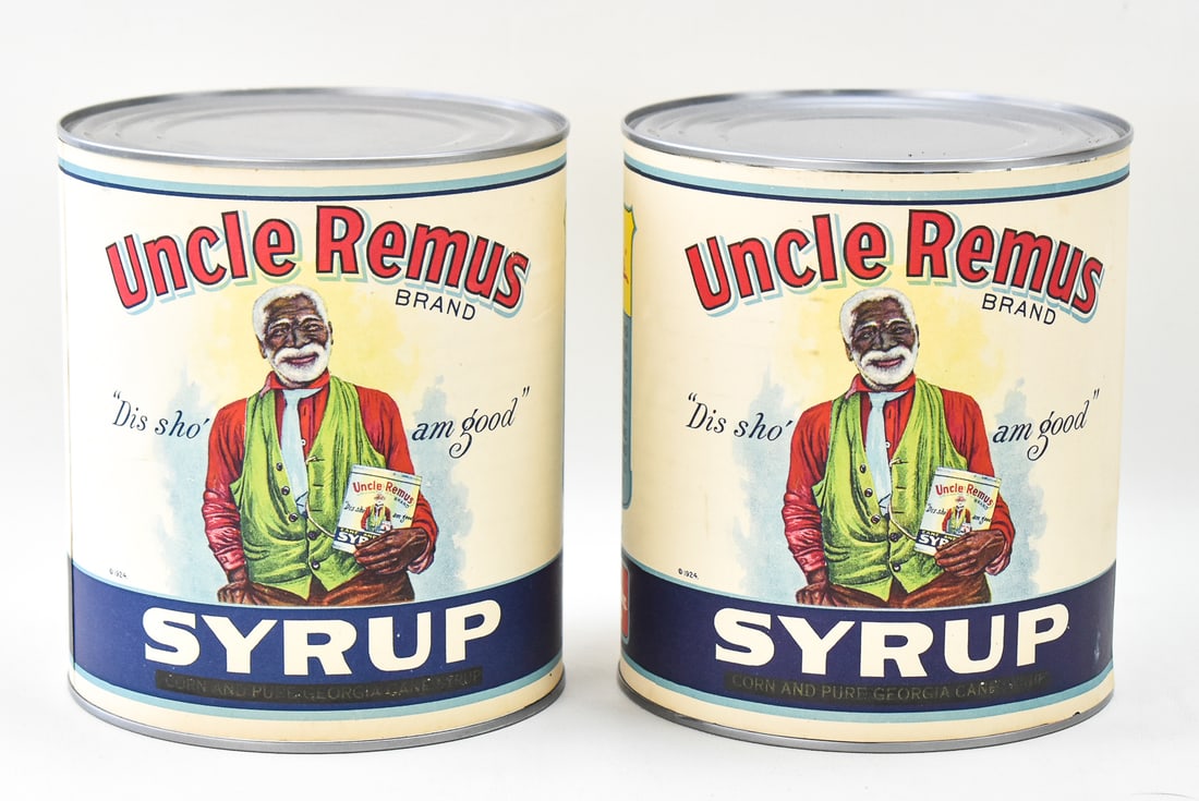 TWO CONTEMPORARY UNCLE REMUS SYRUP DRUM TINS: This lot includes two contemporary Uncle Remus syrup drum tins. The lot measures 7" H x 12.5" W x 6.5" D.