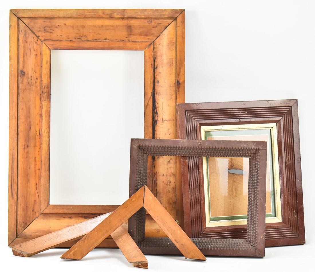 ASSORTED ANTIQUE WOODEN PICTURE FRAMES: An assortment of antique primitive-style wooden picture frames, including one in bird's eye maple. The largest frame measures 25" H x 19" W x 1.75" D.