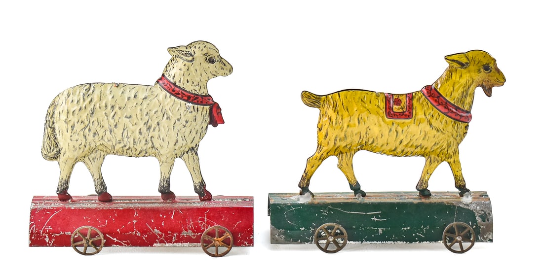 HULL & STAFFORD (ATTR.) PRESSED TIN PULL TOYS: SHEEP AND GOAT: This lot includes two Hull & Stafford (attr.) pressed tinplate pull toys of a sheep and a goat, circa turn of the 19th century. The lot measures 7" H x 7" W x 5" D.