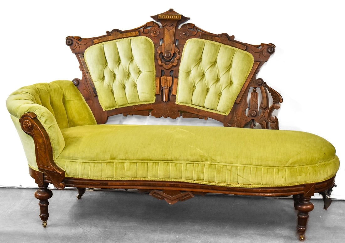 VICTORIAN EASTLAKE CHAISE LOUNGE: A late 19th century walnut and burl Victorian Eastlake chaise lounge with seat, tufted back and armrest in light green velvet, measuring 42" H x 66" W x 26" D.
