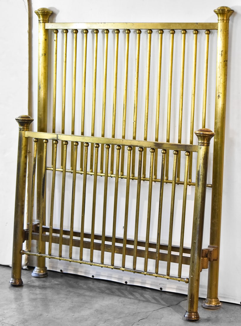ANTIQUE TWIN-SIZE BRASS BED FRAME: An early 1900s twin-size brass bed frame. The headboard measures 54" H x 44" wide, and the footboard is 34" H x 44" W.