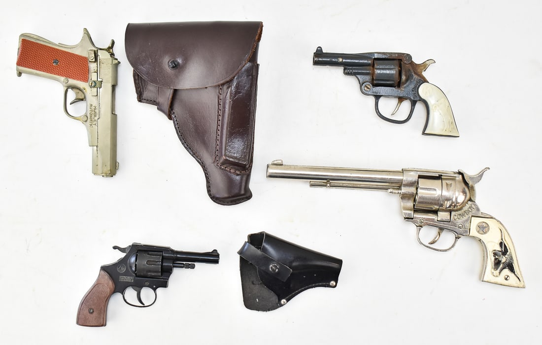 COLLECTION OF CAP GUNS: A collection of vintage toy cap guns, including a Hubley Automatic with a holster, a Hubley Cowboy revolver to scale at 12" L, a Kenton Six-Shooter revolver, and a Mondial Mod 99X revolver.