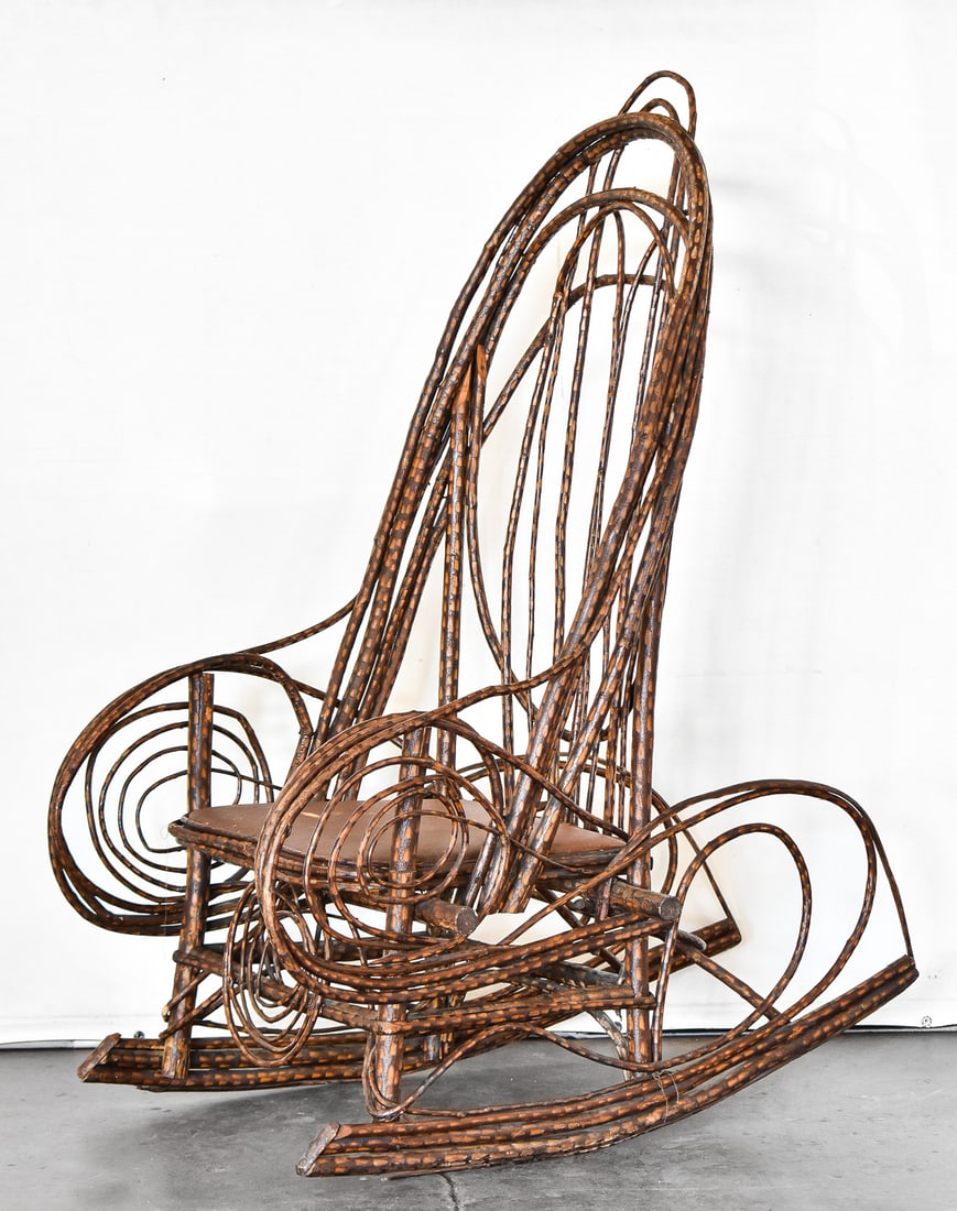 EARLY ADIRONDACK BENTWOOD TWIG STYLE ROCKER, 19TH CENTURY: An Adirondack bentwood twig style rocker with a repurposed Portland Crackers seat base, circa turn of the 19th century. The item measures 47.5" H, 25" W, 35.5" D.