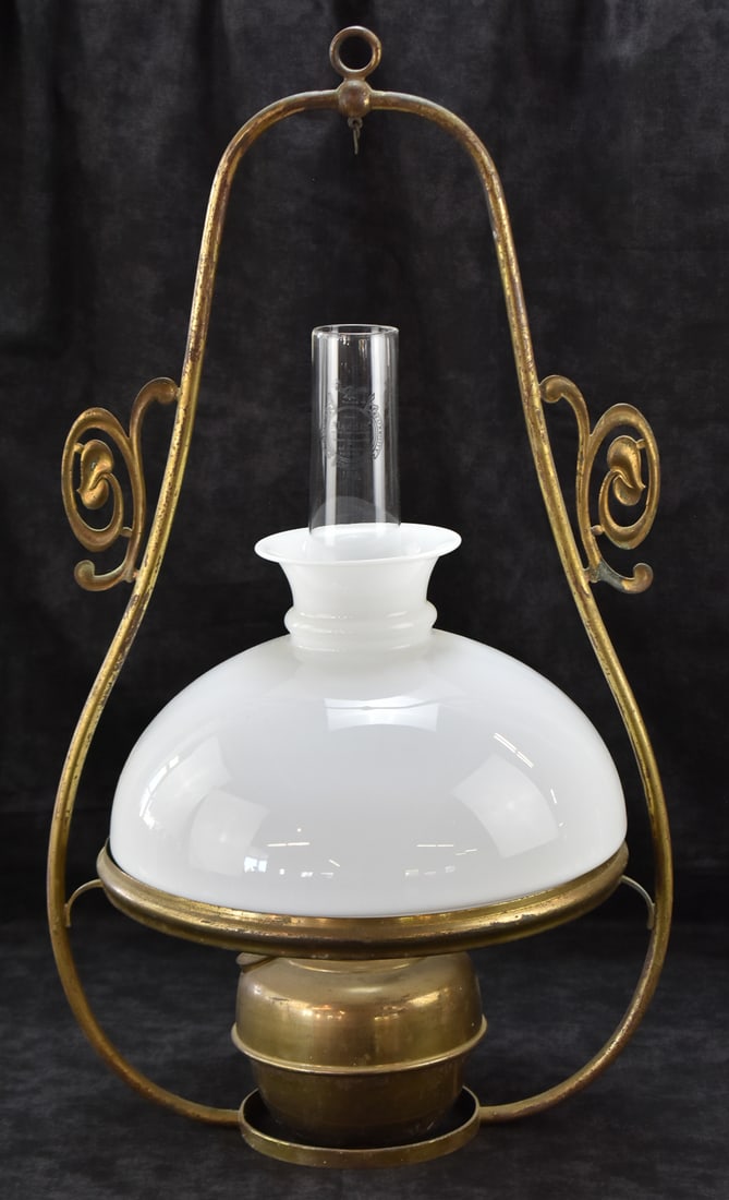 VICTORIAN BRASS HANGING OIL LAMP: A Victorian brass hanging oil lamp, circa late 19th century. The item measures 29" H, 15" W, 12" D.