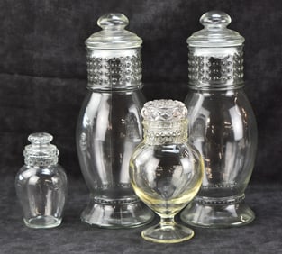 FOUR VINTAGE GLASS CANDY DISPLAY JARS