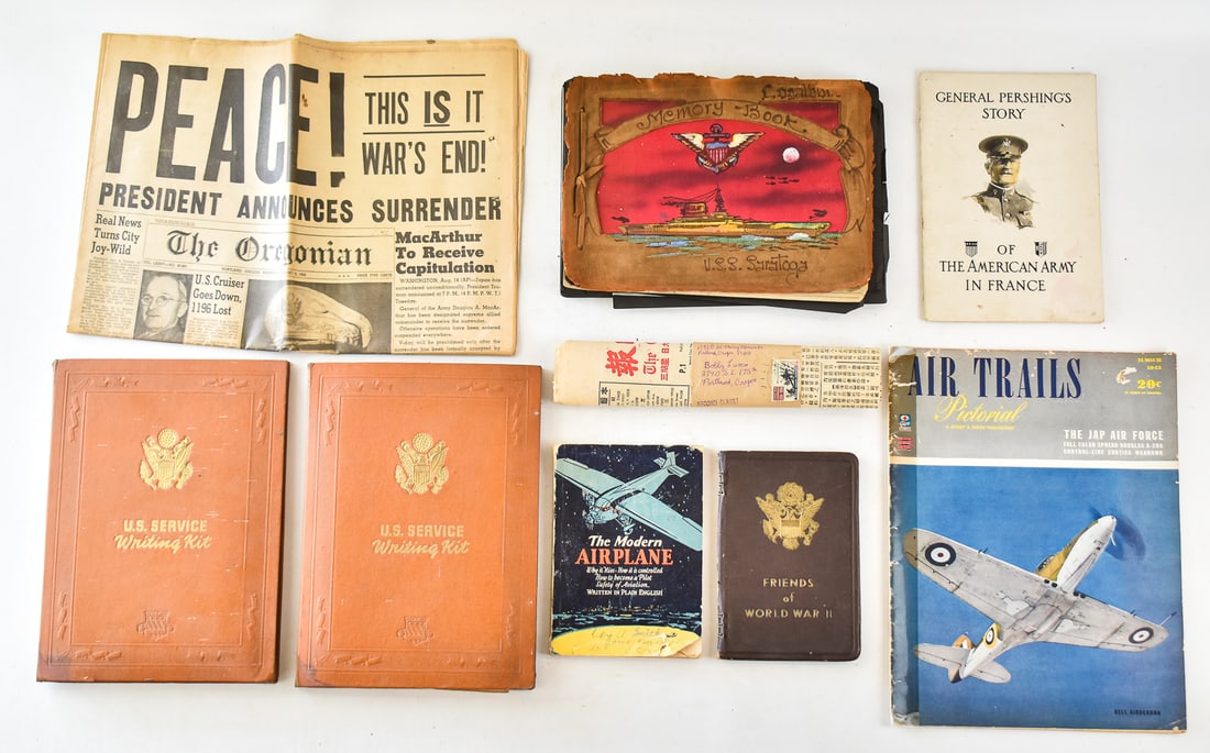 COLLECTION OF WWII ERA MILITARY EPHEMERA: Includes a Friends of WWII unused address book, a U.S.S. Saratoga memory book with signatures and photographs, two U.S. Service writing kits with Army letterhead, an August 15, 1945 Oregonian newspape
