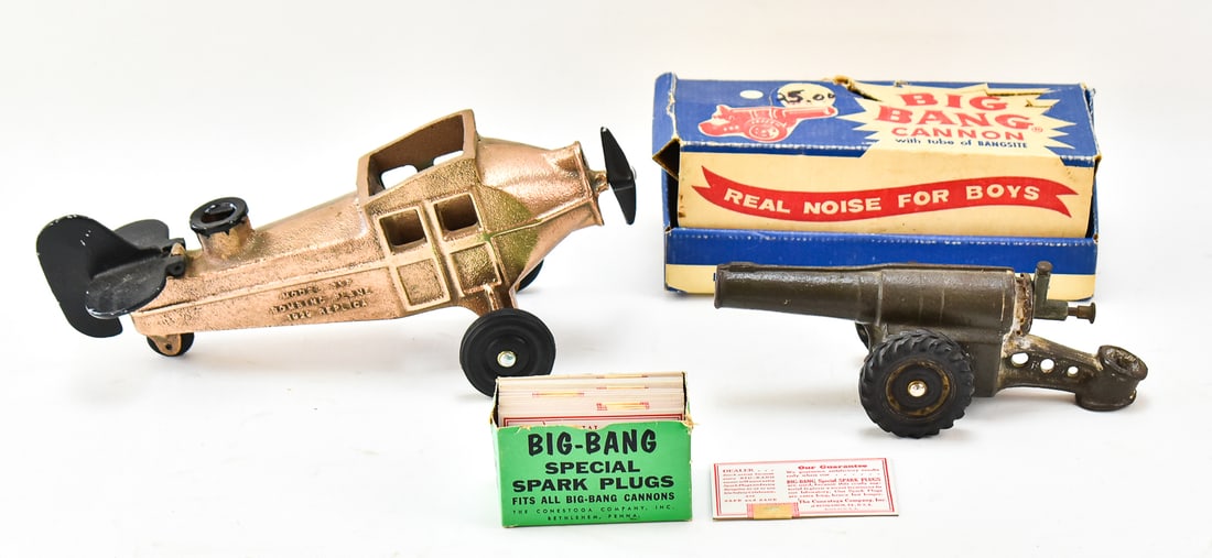 CONESTOGA COMPANY INC. 'BIG BANG CANNON' & REPLICA MODEL 11P BOMBING PLANE: A Conestoga Company Inc. "Big Bang Cannon" with original replacement "spark plug" cards, c. 1920, and a replica bronze Big Bang Model 11P Bombing Plane. The plane measures 12" L.
