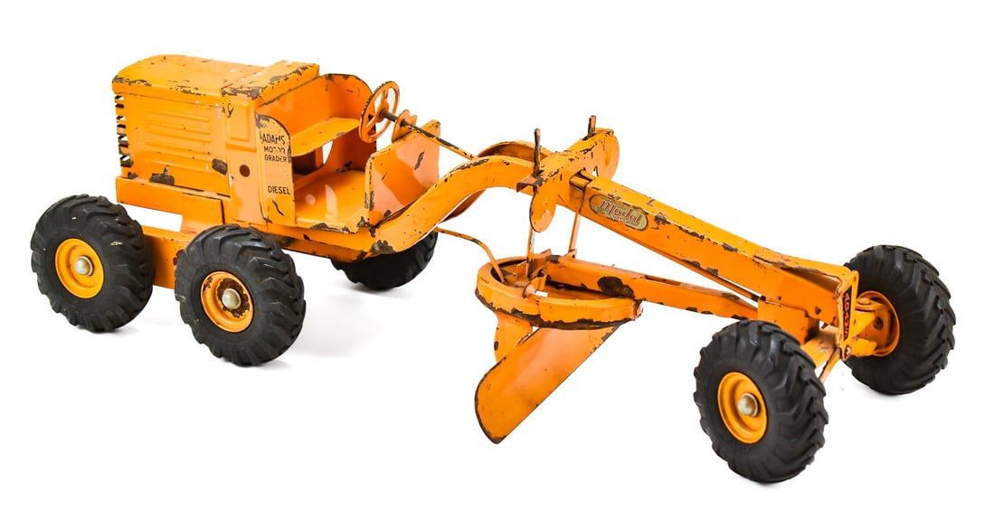 DOEPKE MODEL TOYS ADAMS DIESEL MOTOR GRADER: A 1950s Doepke Model Toys orange Adams diesel motor grader, measuring 8" H x 27" W x 10" D.