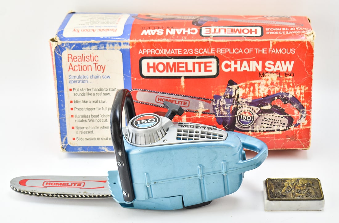 VINTAGE HOMELITE CHAINSAW MODEL 150 CHILDREN'S TOY & BOX: A Homelite chainsaw model 150 children's toy with an original box and plaque, circa 1970s. The item measures 5.5" H, 16" W, 7.5" D.
