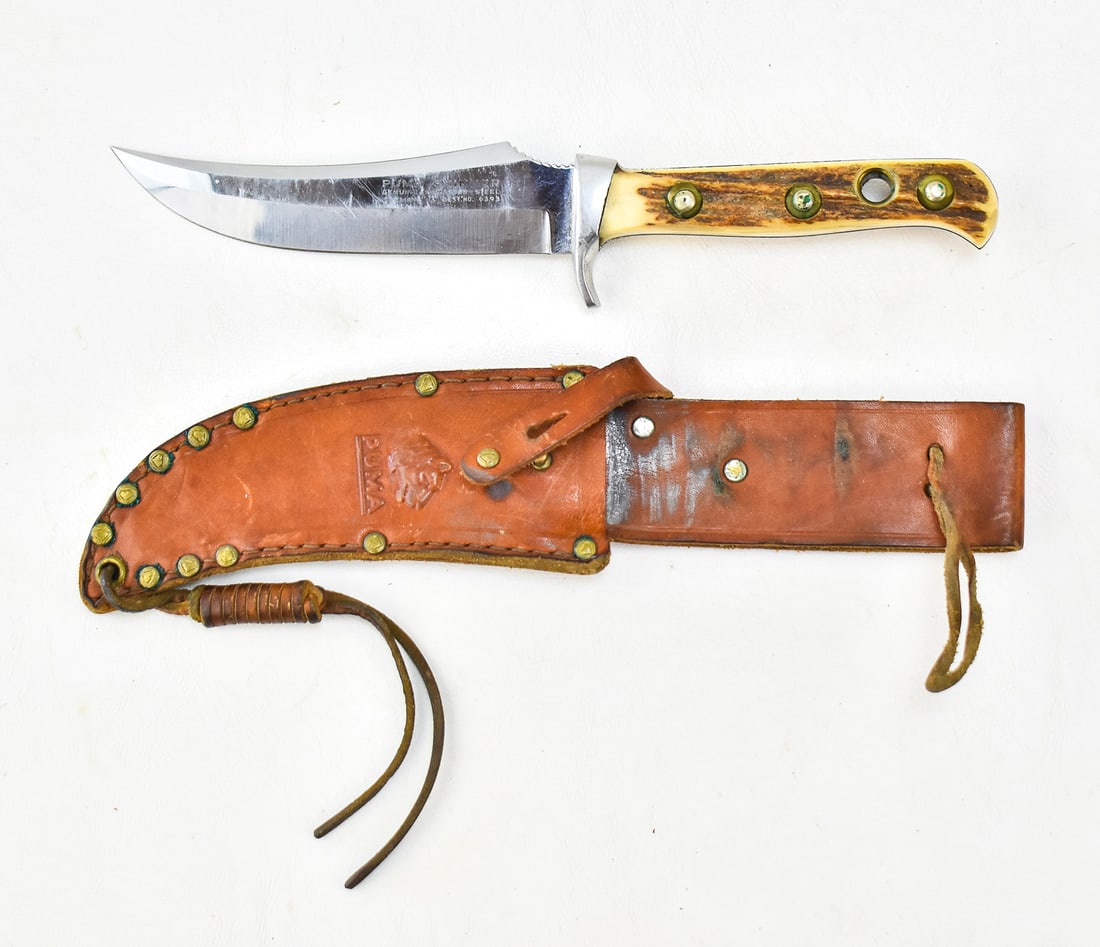 PUMA SKINNER NO. 6393 STAG HORN KNIFE: A Puma Skinner No. 6393 knife with a stag horn handle and a leather sheath. The item measures 10" H, 2.5" W, 1" D with a 5" blade length.