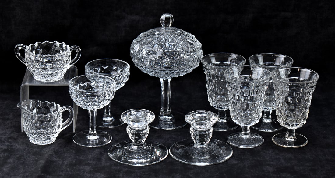 COLLECTION OF FOSTORIA CLEAR AMERICAN PATTERN GLASSWARE: A collection of Fostoria clear American pattern glassware, including creamers, candlesticks, goblets, etc. and a lidded compote measuring 9" H.