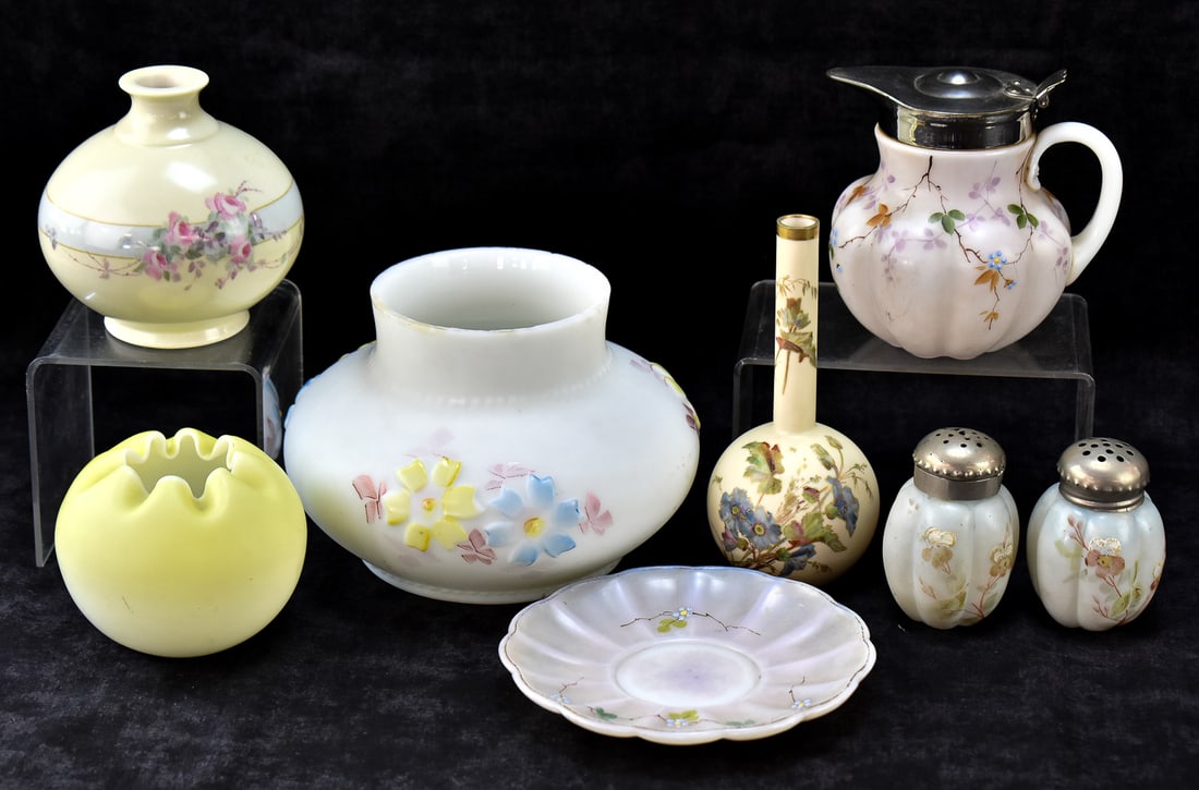 COLLECTON OF HAND-PAINTED SATIN MILK, CUSTARD, & IVORY GLASSWARE: A collection of hand-painted floral decoration pieces made of satin milk and custard glassware, and one of bone china. This lot includes a pair of shakers, a saucer, a rose bowl, a cosmos pattern oil