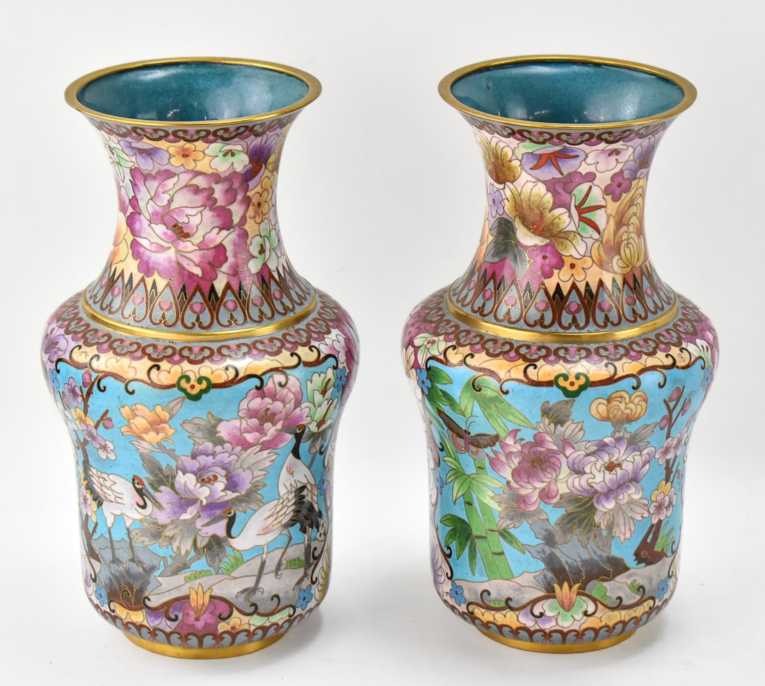 PAIR OF 20TH CENTURY CHINESE CLOISONNE VASES: A pair of 20th century Chinese cloisonne vases with heron or crane, floral famille rose, and gestural Qing-style motifs. Each vase measures just over 10" H.