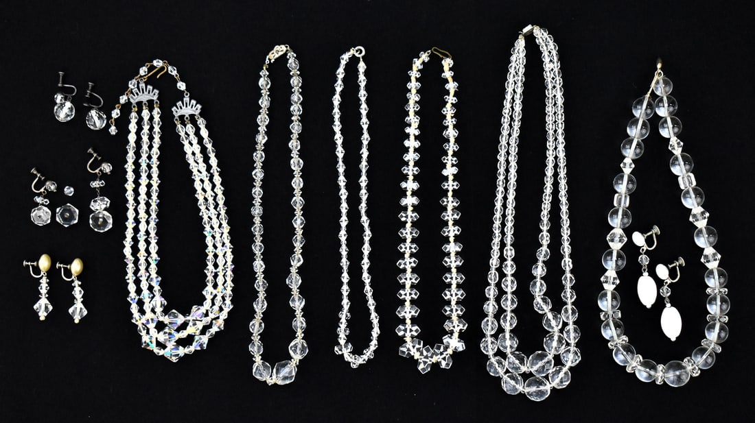EARLY 20TH CENTURY CRYSTAL JEWELRY: A lot of early 20th century iridescent cut crystal jewelry including necklaces, bracelets, and earrings. The art deco three-string necklace measures 15" L overall, for reference.
