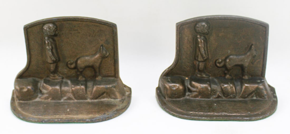 BRONZE-GILDED CAST METAL BOOKENDS: A pair of bronze gilt painted cast metal bookends featuring a child and dog in relief. Each bookend measures 4.5" H x 6.5" W x 3" D.