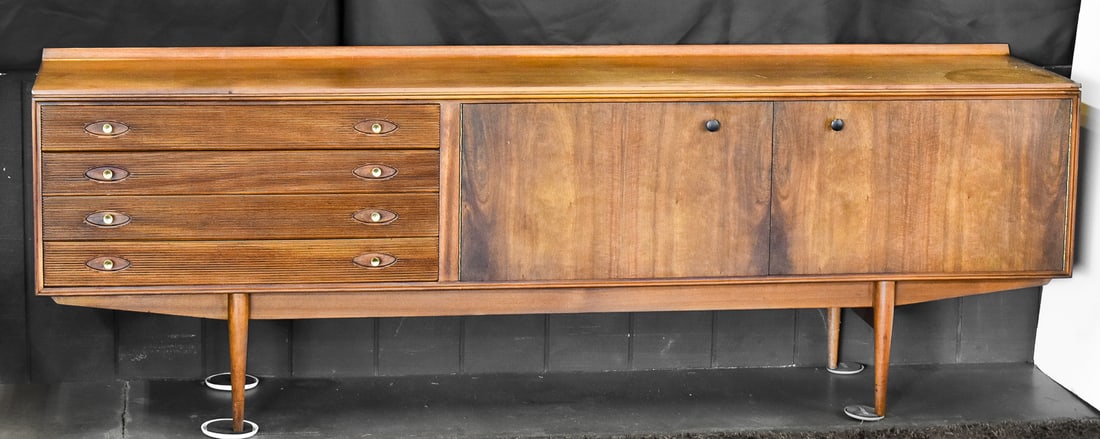 MID-CENTURY 'HAMILTON' WALNUT SIDEBOARD DESIGNED BY ROBERT HERITAGE FOR ARCHIE SHINE: Mid-Century "Hamilton" sideboard by Robert Heritage for Archie Shine, made in the 1960s and finished in walnut with a long, low profile. The arrangement combines four drawers with brass pulls on the l