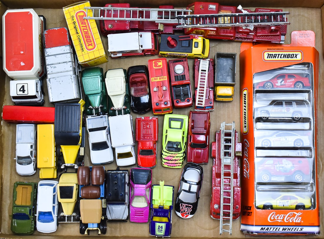 COLLECTION OF MATCHBOX CARS: A collection of approximately Thirty-Five Matchbox cars from the late 1900s, including fire trucks, Coca-Cola, and a variety of other model. Many of the Matchbox cars are older models marked "Lesney"