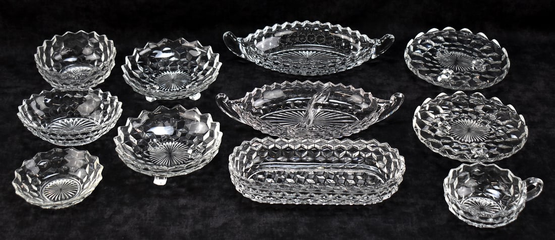 ASSORTED FOSTORIA 'AMERICAN' SERVING ITEMS: Eleven pieces of Fostoria "American" pattern serving items includes two footed bowls, one celery dish, one divided dish, three small serving bowls, two footed plates, one handled bowl, and one oval di