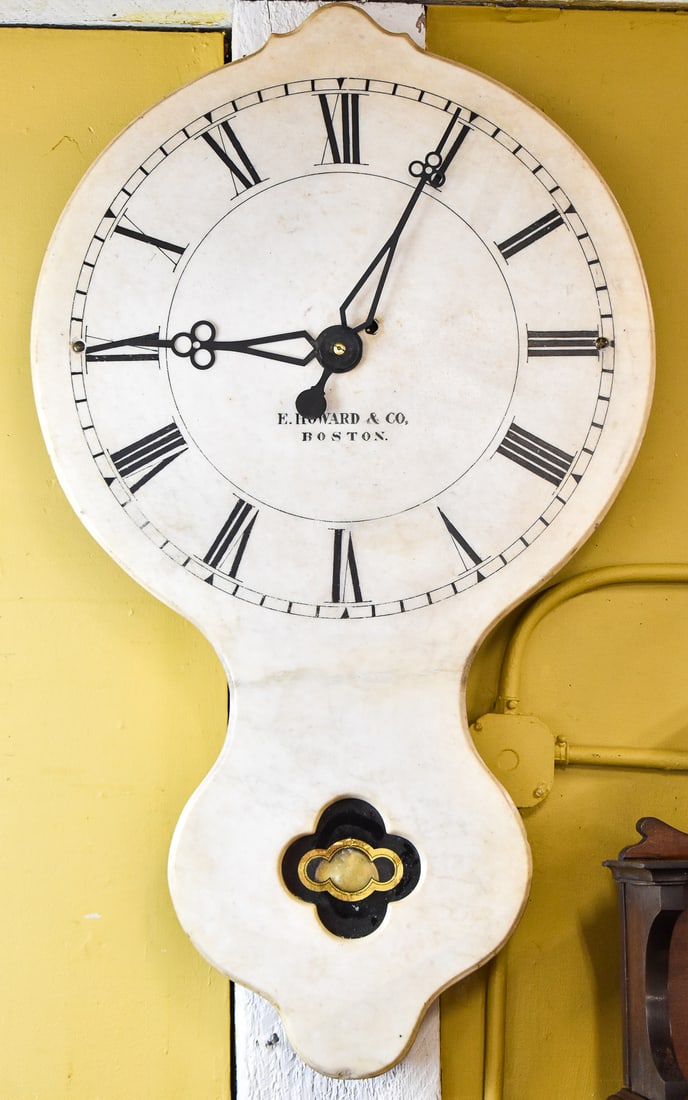 EDWARD HOWARD & COMPANY EIGHT-DAY MARBLE LIGHTHOUSE WALL CLOCK NO. 17: An Edward Howard & Company eight-day single slab white marble wall clock No. 17 (Light House) with a Roman numeral dial, and three-leaf clover hands, and a sticker which reads "Property of United Stat