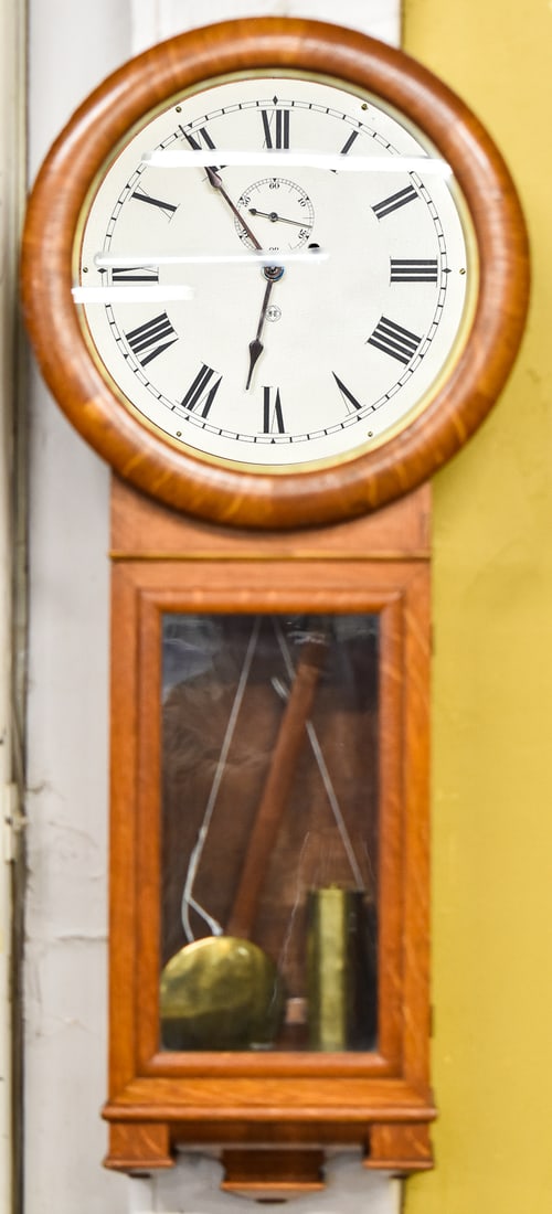 EARLY 20TH C. SETH THOMAS NO. 2 OAK WALL CLOCK: An early 20th century Seth Thomas wall clock in oak, measuring 37" H x 16" W x 5.5" D.
