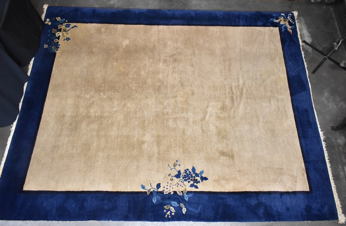 EARLY 20TH C. CHINESE PEKING-STYLE AREA RUG: A Chinese Peking-Style blue and beige floral area rug, circa early 20th century. The rug measures 142" L x 112" W.