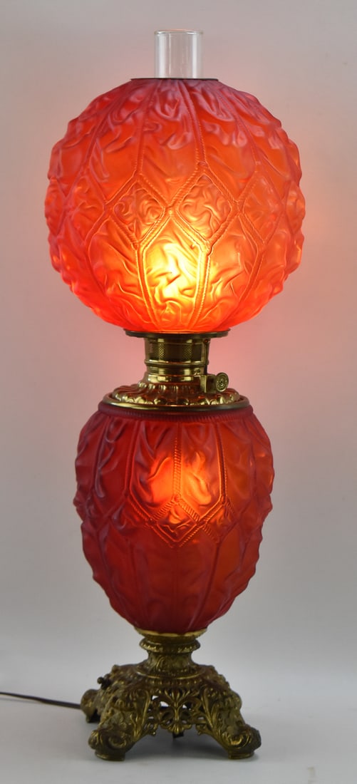 VICTORIAN CONSOLIDATED LAMP COMPANY 'IMPERIAL' GONE WITH THE WIND PARLOR LAMP: An electric Consolidated Lamp Company "Imperial" diamond drape red satin glass Gone with the Wind parlor lamp with a brass base, patented 1895. The item measures 29" H, 8" W, 8" D.