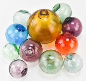 ELEVEN 20TH CENTURY GLASS FISHING FLOATS: NORTHWESTERN GLASS COMPANY
