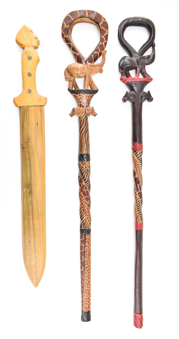 PAIR OF AFRICAN WALKING STICKS & 'JAMAICA' SWORD: A pair of African carved walking sticks or canes with decorations such as giraffes, and a handmade sword made from English blade stock marked "Jamaica WI" on the wooden scabbard. The sword measures