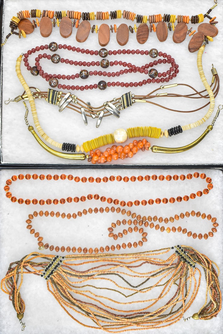 COLLECTION OF MID-CENTURY AFRICAN STYLE BEADED NECKLACES: A collection of Mid-century beaded necklaces, most of which are in African styles, including silk beads, agate, carved wood, metals, resin, and clay beads. The African clay bead necklace measures 24"