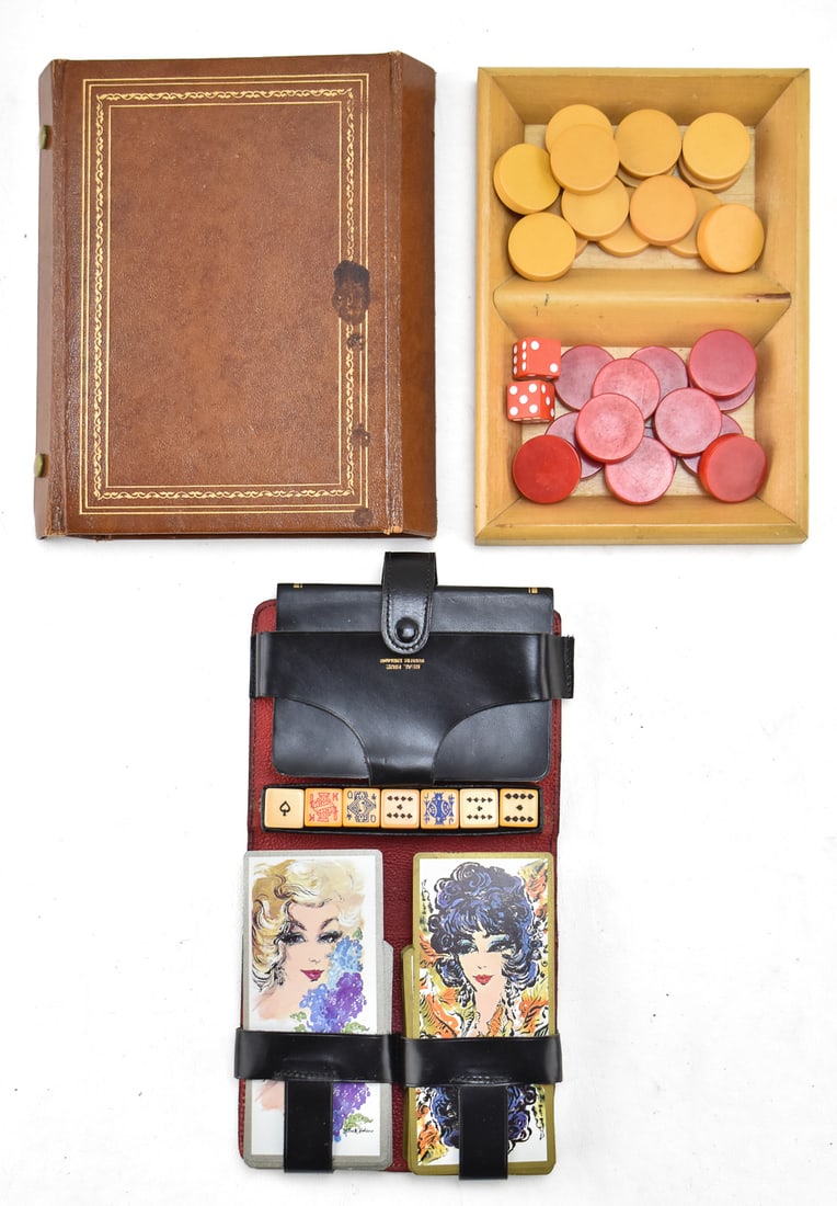 PAIR OF VINTAGE MID-CENTURY GAME SETS: A pair of vintage Mid-century game sets including a Hoyle's Game Guide made in England with two decs of cards and dice, and a Bakelite checkers set with a Permo leather case. The checkers set