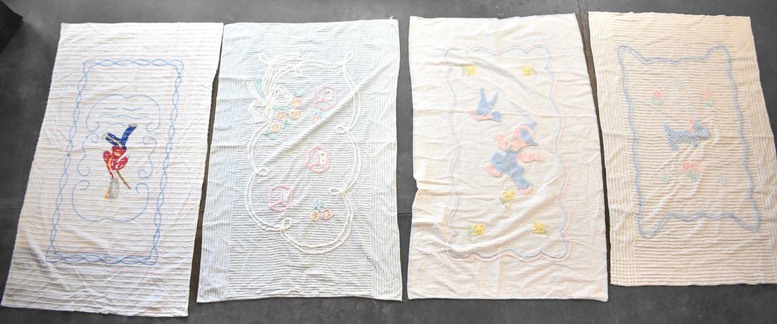 COLLECTION OF MID-CENTURY EMBROIDERED NURSING BLANKETS: A collection of Mid-century embroidered nursing blankets with blue and pink frills, most of which are twin sized and measure about 63" H x 44" W x 0.25" D.