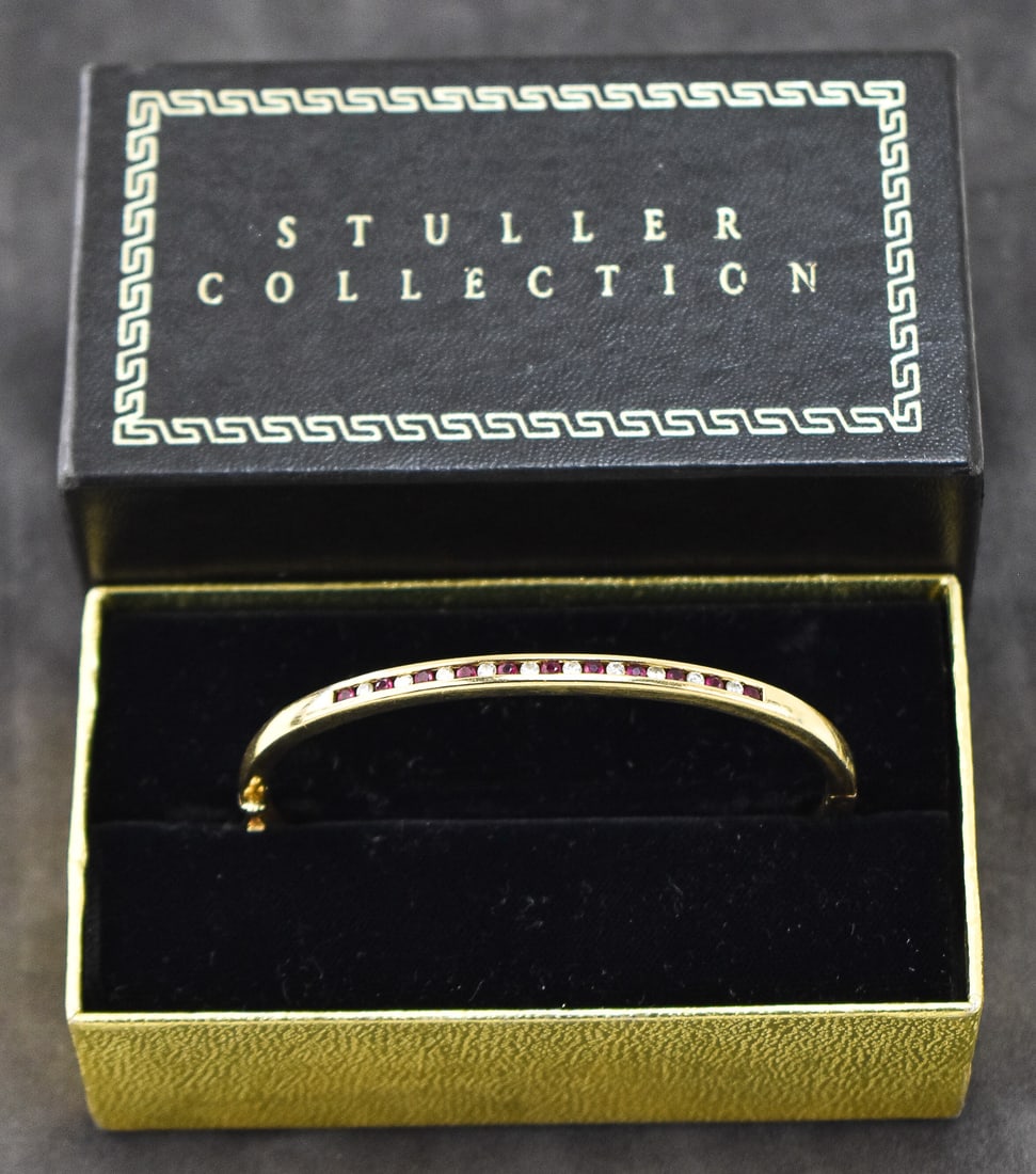 STULLER COLLECTION 14K GOLD BRACELET WITH DIAMONDS & RED SPINEL: A Stuller Collection 14k gold bracelet with ten small diamonds and eleven small red spinel stones. The clasp is marked 14k. The bracelet has a weight of 15.6 grams and measures 2" H x 2.25" W x 1/8" D