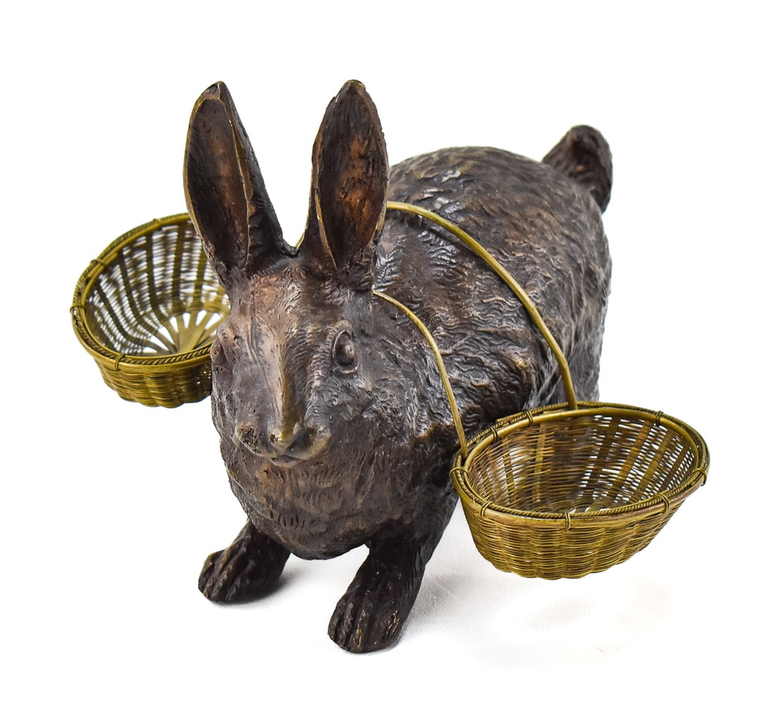 CAROLE STUPELL (ATTR.) EDWARDIAN STYLE PATINATED BRONZE RABBIT FIGURINE: A Carole Stupell (attributed) Edwardian style patinated bronze rabbit figurine with woven brass baskets. The item measures 6" H, 7.5" W, 3" D.