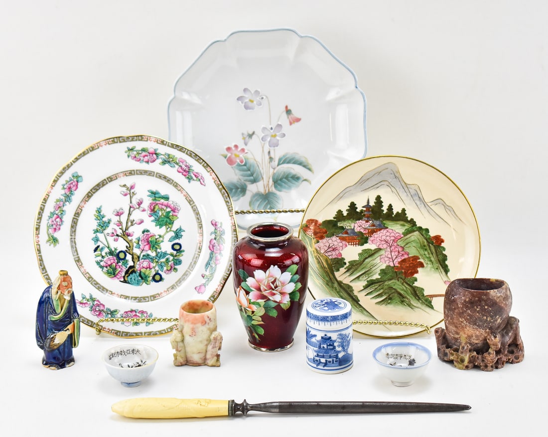 COLLECTION OF ASIAN PLATES, SOAPSTONE, SAKI CUPS & MORE: A collection of Asian items: three hand-painted plates, a sharpening rod with a hand-carved dragon handle, two early 1900s saki cups, one figurine of an elder man, a lidded blue and white porcelain to