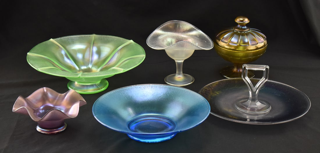 COLLECTION OF SATIN & STRECHED GLASS NORTHWOOD, FENTON AND MORE: A collection of six pieces which includes; a Fenton stretch flared Florentine green bowl, a Dugan diamond blue stretch bowl, an amethyst stretch footed bowl, a Northwood covered candy dish, a center
