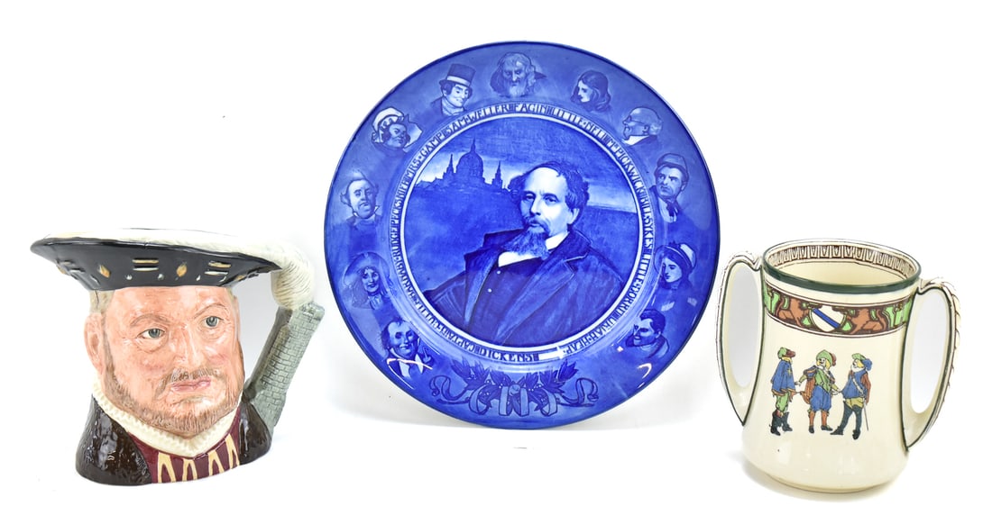 ROYAL DOULTON: 'CHARLES DICKENS' PLATE, NEW CAVALIERS DRINKING CUP, & KING HENRY VIII TOBY MUG: This lot includes the following Royal Doulton pieces: "Charles Dickens Portraits and Characters" monochrome transferware plate circa 1908-1916, double-handled new cavaliers drinking cup circa 1902-192